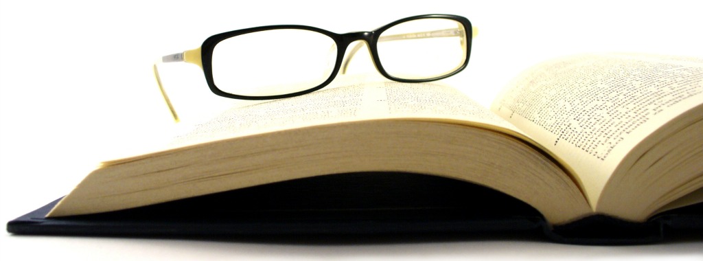 Dictionary book with women’s glasses
